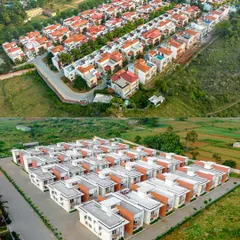 An aerial comparison showing two different types of housing developments within the same area, highlighting the diversity of residential real estate projects we cover.