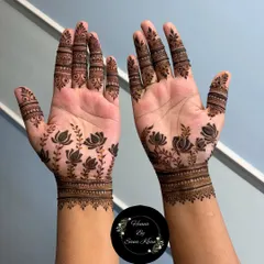 This elegant design features lotus flowers, a symbol of purity and beauty. The pattern is simple yet striking, with detailed work on the fingers and a clean wristband.
