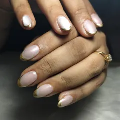 A modern twist on a classic. This look features a clean, natural base with a striking gold chrome French tip. It's an elegant and sophisticated design that shows how a small detail can make a huge impact, perfect for when you want your nails to look effortlessly chic.