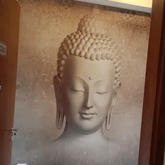 A close-up of a 3D-effect Buddha face mural. The neutral tones and calm expression make it ideal for creating a tranquil atmosphere.