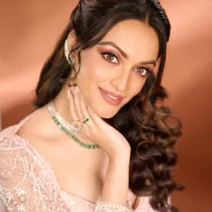 A beautiful portrait that highlights the radiant skin and sparkling eyes of this reception look. The soft waves and delicate jewelry perfectly complement the understated yet glamorous makeup.