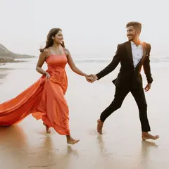 A happy, candid moment from a beach pre-wedding shoot. We have light, flowy gowns and smart suits perfect for a relaxed seaside setting.