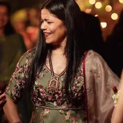 A candid moment of joy. This close-up shows the hand-highlighted floral print on the satin anarkali, detailed with french knots, beads, and katdana.