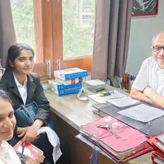 In my office with law interns, surrounded by case files. It is crucial to train young lawyers in social justice law and show them how to use their skills to defend the rights of the exploited.