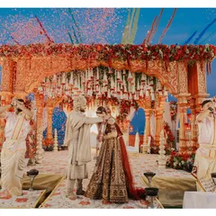 A vibrant Varmala moment, complete with a shower of confetti. We capture the energy and excitement of this key Hindu wedding ritual.