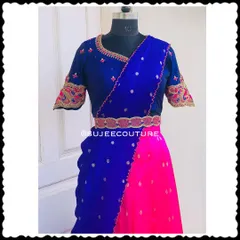 A vibrant and youthful Langa Voni. This set features a bold color-blocked look with a royal blue blouse, a hot pink skirt, and a blue dupatta, all accented with delicate embroidery.