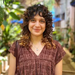It's giving QUEEN. We love a curly cut with a fringe, and this look is all about breaking free from the norm. The subtle highlights on the ends make the shag cut pop.