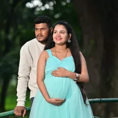 A lovely couple portrait during their maternity shoot. The light blue gown complements the natural, green surroundings perfectly, making for a serene and happy picture.