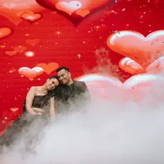 A dreamy and romantic shot from a Sangeet performance. Using elements like stage smoke and a backdrop of hearts, I create a magical atmosphere that makes your couple's dance look and feel truly special.