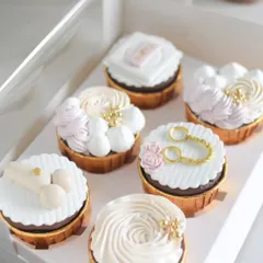 A close-up of the custom cupcakes for a bachelorette party. I created fun, themed fondant toppers to go with the Salted Caramel and Strawberry Chocolate cupcake flavors.