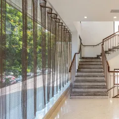 An undulating mesh curtain was introduced along the glass facade of the Nalli store. This element controls the intense glare of the Chennai sun while adding a layer of translucency and texture to both the interior and exterior.