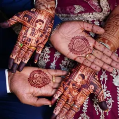 A beautiful shot of the bride and groom's hands together, showcasing the detailed portraits and the complementary design for the groom.