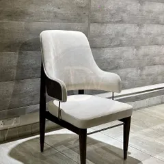 A contemporary dining chair with a classic touch. The off-white upholstery contrasts beautifully with the dark wood frame, making it a versatile choice for modern dining rooms.