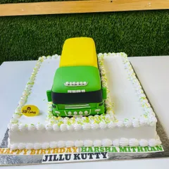 A massive 5kg sculpted cake of a green and yellow cargo truck, perfect for a transportation-loving birthday boy.