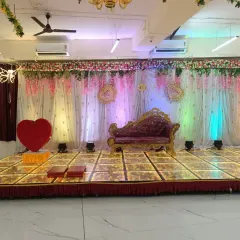 A beautiful stage setup for an engagement ceremony at our Badlapur hall. The elegant divan, floral backdrop, and illuminated LED dance floor create a perfect setting for your special moments. This is a popular choice for a small wedding reception venue.