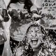 The pure, unfiltered joy of a haldi ceremony. We live for these moments of beautiful chaos, capturing the laughter and celebration with friends and family in timeless black and white.