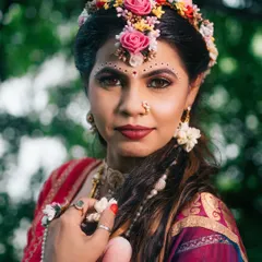 A close-up portrait from our Radha-themed shoot, focusing on the expressive eyes, floral crown, and traditional makeup that tell a story of divine love.