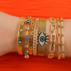 Getting your arm party summer-ready. This stack features some of my favorite evil eye and link chain bangles, perfect for adding a pop of color and protection to your look.