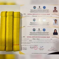 The official WAKO India Kickboxing Federation certificates and yellow belts awarded to our students, a symbol of their hard work and achievement.