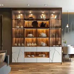 Our modern crockery cabinets are designed to display your finest dinnerware. This unit features a blend of wood, glass doors, and a marble-finish base, with internal backlighting to highlight your collection. It provides both open display shelves and concealed drawers for versatile storage.