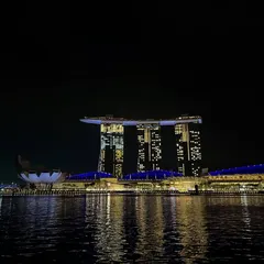 A postcard from Marina Bay, Singapore. This iconic shot captures the stunning architecture and vibrant nightlife of the city, creating aspirational travel content.