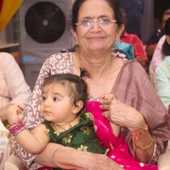 A heartwarming portrait of a grandmother holding her baby granddaughter. We specialize in multi-generational photography, capturing the precious bond between family members.