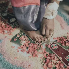 A close-up of a bride's feet during the toe ring ceremony, a significant ritual in many South Indian weddings. I focus on these details to tell a complete wedding story.