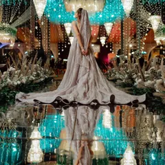 A stunning wide shot of the bride's reception look, her magnificent gown reflected in the glossy aisle, creating a breathtaking image of glamour and elegance.