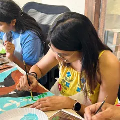 A participant adding fine details to her beautiful portrait-themed tote bag. It's a wonderful way to combine fashion and art.