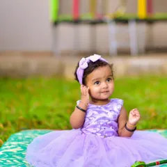 A quiet, thoughtful moment during an outdoor session. I aim to capture the full range of your baby's expressions, not just the smiles, to create a complete and honest portrait of who they are at this stage.
