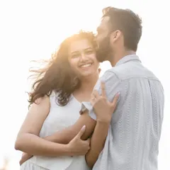 A sun-kissed portrait from a Goa pre-wedding shoot. The golden light and the bride-to-be's joyful smile perfectly capture the happiness of the moment.