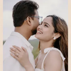 A beautiful, happy close-up of Pooja and Gaurav, with the rolling green hills of Udaipur creating a soft, romantic background.