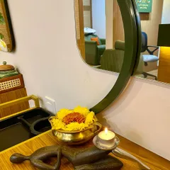 A simple candle, a brass bowl of fresh flowers, and a traditional sculpture. These elements reflect my philosophy of finding beauty and peace in simplicity.