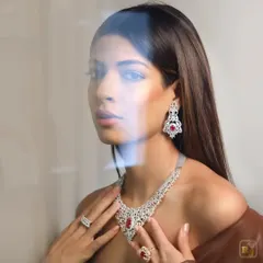 A duplicate of image 125, this shot through a reflection adds an artistic touch. The makeup remains understated and elegant, letting the luxury product shine.