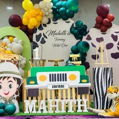 Welcome to the jungle. We had so much fun designing this 'Wild One' safari theme for Mahith's birthday. The setup included a custom backdrop, balloon garlands, and large cutouts of a safari jeep, a friendly explorer, and lots of animals.