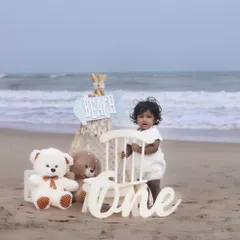 Let's take the celebration outdoors! This first birthday beach photoshoot combines a beautiful natural setting with our curated props for a unique and memorable milestone session. We handle the setup so you can enjoy the moment.