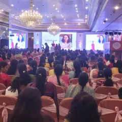 A wide shot of the audience viewing a presentation on our dual-screen setup. The large, bright displays ensure clarity even in a large, well-lit hall.