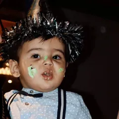 A candid shot from my nephew's first birthday party, with cake on his face and a party hat on. Capturing these real, unposed moments is what makes event photography so special.
