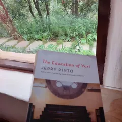 'The Education of Yuri' by Jerry Pinto finds a perfect reading spot by a window overlooking the lush greenery of the retreat.