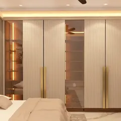 This master bedroom showcases a sophisticated wardrobe design with illuminated glass panels, offering a peek at the organized interior. The combination of fluted textures and metallic handles adds a touch of luxury and elegance.