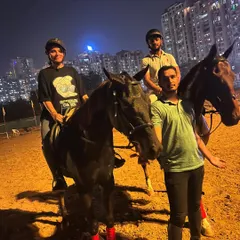 A group of friends and a trainer pose for a photo after a fun night ride. It's a great way to socialize and share a unique experience.