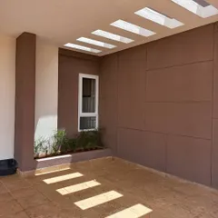 The play of light and shade is a fundamental part of my design philosophy. Here, rectangular skylights cast rhythmic patterns on the floor, turning a simple covered walkway into a dynamic, sun-drenched space.