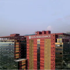 A closer view of the Rupa Renaissance rooftop and facade, showing the branding and the building's signature color scheme. The design considers climate and sun incidence to create a comfortable and self-sustainable working environment.
