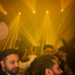 A view from the crowd as the lights create a spectacular effect. My aim is to build a party where every guest feels like they are part of the show.