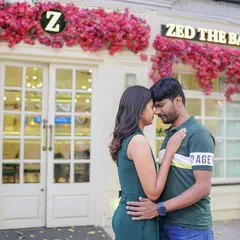 An intimate forehead touch in front of a beautifully decorated bakery. This urban setting provides a charming and romantic backdrop for a couple shoot.