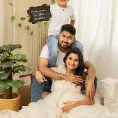 Promoted to Big Brother. This is such a fun and proud moment to capture. The whole family is beaming with joy in this lovely studio portrait.
