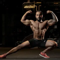 A classic bodybuilding pose showing overall muscularity, from the biceps and chest to the leg definition. This is what peak physical condition looks like.