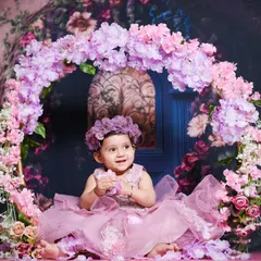 A candid moment of this little princess playing with flowers in our dreamy, floral-themed studio setup.