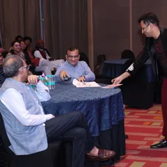 A quiet moment of mind-reading during an awards ceremony for Balrampur Chini Mills. Even in a more formal seated environment, I can engage with guests at their tables, performing illusions that are personal and captivating.