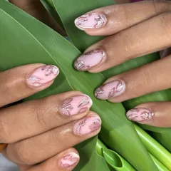 A beautiful and delicate design featuring a soft nude matte base with rose gold floral accents and a silver cat-eye shimmer that shifts in the light.